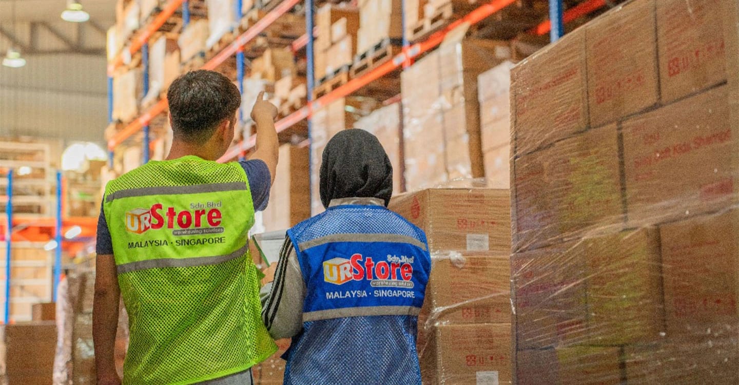 URStore warehouse staff inspecting and preparing packages in the warehouse before delivery.